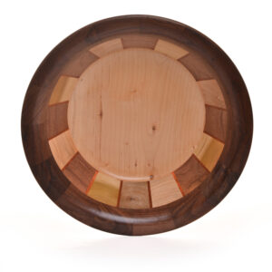 Segmented turned bowl made using Walnut, Maple, Poplar and Brazilian Cherry. No stains are used. All woods are natural color.