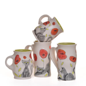 Small mug decorated with a cute kitty and Poppy flowers. Meghan’s cat, Twinkie, inspired these sweet cat designs! Each piece is thrown porcelain on the wheel and then carved. After each piece dries the black lines are carved into the porcelain with a sharp knife, then inlaid with black under-glaze. Each color is hand painted before being glazed with food safe glazes.