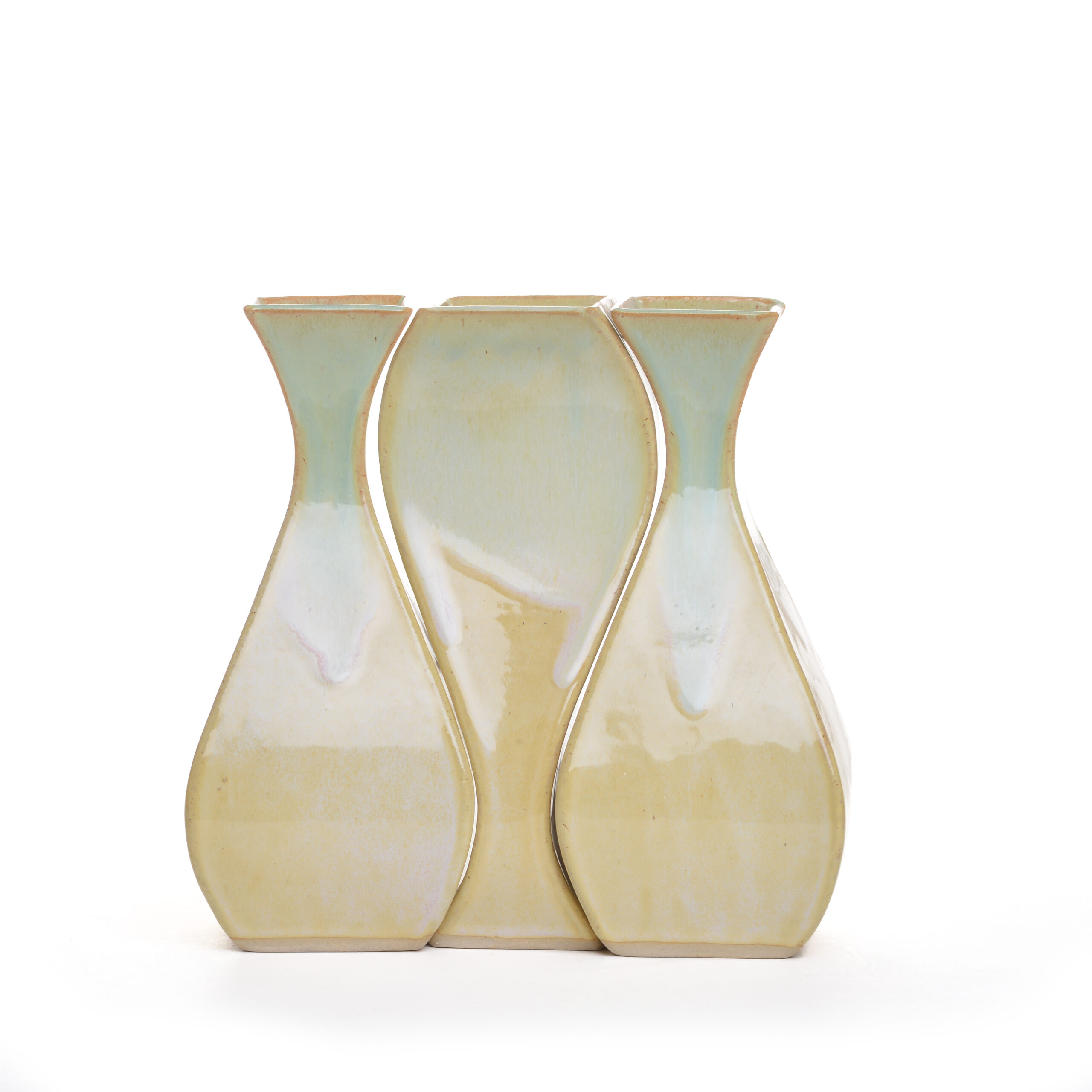 A set of three vase that fit together and utilize the negative space between them. Hand formed from clay slabs and pieced together and then high-fired. Rob and Beth Mangum high-fires their pieces for superior durability. Expect slight differences in shape, pattern and glaze.