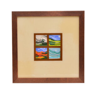 Framed fused glass panel with bright mountain landscapes. The landscapes are bordered with cream glass, not a mat.
