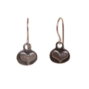 These dainty heart dangle earrings are cast from a granulated original and are cast using the lost wax process. Susan cuts out a heart of fine silver and fuses it to an oval background using the ancient fusing process of granulation. They have a nice weight and look great on!
