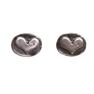 These dainty heart post earrings are cast from a granulated original and are cast using the lost wax process. Susan cuts out a heart of fine silver and fuses it to an oval background using the ancient fusing process of granulation.