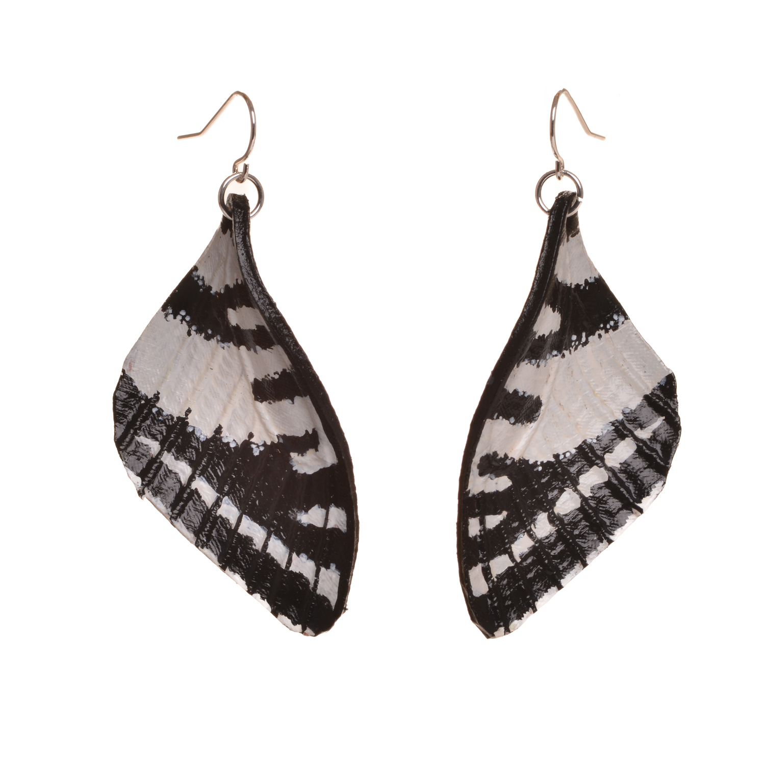 Zebra swallowtail butterfly earrings, hand tooled and painted on tanned leather. Thin, slightly flexible and very light. The design is drawn on the leather, tooled, cut out and shaved down thin. They are then soaked with a leather dye that stiffens the leather, and shaped as they dry. Finished with a coat of clear sealer.