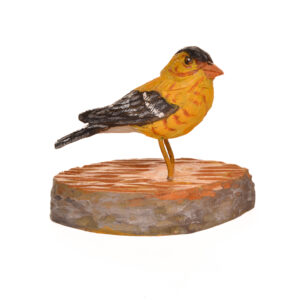Realistic hand-carved and painted Goldfinch. Masterfully painted and posed. John Dickens carves each piece with an ordinary pocketknife. John has been carving wood for 48 years. John wrote, “each time I do an animal, I want to do it in a different pose so I can learn more about its anatomy and how it moves and behaves.” His primary subjects are the local songbirds found at his backyard bird feeder, animals, fish, people and reliefs.