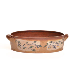 Wheel thrown handled baking dish with hand painted twigs and berries with a warm brown glaze by artist Ann Gleason.