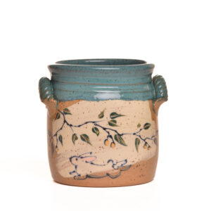 Handled utensil holder with hand-painted berry twigs and bunnies on a contrasting sage glaze by artist Ann Gleason.