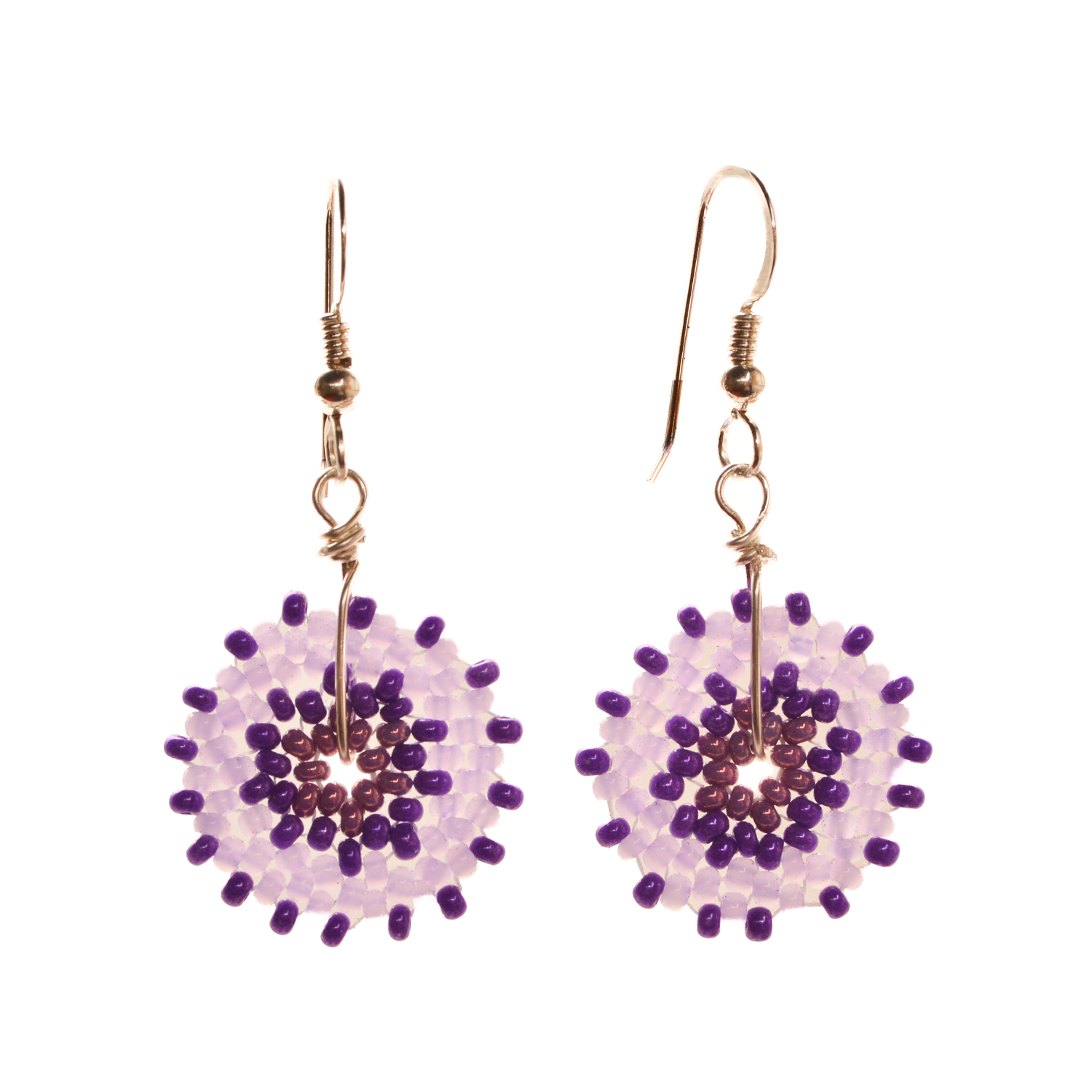 Round disk earrings featuring handwoven glass seed beads by jeweler Leslie Fawcett of Tennessee. With a needle and nylon thread, Leslie takes tiny glass seed beads and weaves them into larger beads that are then rolled up and sewn together. The use of the peyote stitch allows the ends of the rectangle to interlock when sewn together, and repeated passes through the beads reinforce the whole.