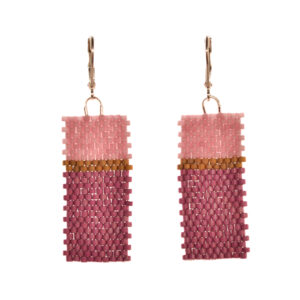 Flat geometric color-block earrings featuring peyote stitch and glass seed beads by jeweler Leslie Fawcett of Tennessee. With a needle and nylon thread, Leslie takes tiny glass seed beads and weaves them into a rectangular piece that is then rolled up and sewn together. The use of the peyote stitch allows the ends of the rectangle to interlock when sewn together, and repeated passes through the beads reinforce the whole.