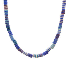 Beaded bead necklace featuring handwoven glass seed beads by jeweler Leslie Fawcett of Tennessee. With a needle and nylon thread, Leslie takes tiny glass seed beads and weaves them into larger beads that are then rolled up and sewn together. The use of the peyote stitch allows the ends of the rectangle to interlock when sewn together, and repeated passes through the beads reinforce the whole.