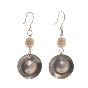 Handcrafted hammered sterling silver circle with freshwater pearl dangle earrings by silversmith Suzanne Farran-Hrytzik of North Carolina. Each earring features a lustrous white freshwater coin pearl wire-wrapped above a dome and hammered sterling silver disc. Easy to clean and great for everyday wear. Expect slight variations in design.
