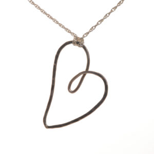 Beautifully designed and handcrafted "Love and Friendship" heart necklace by silversmith Suzanne Farran-Hrytzik of North Carolina. This piece features a playful sterling silver hammered heart. Great for everyday wear. Expect slight variations in design.
