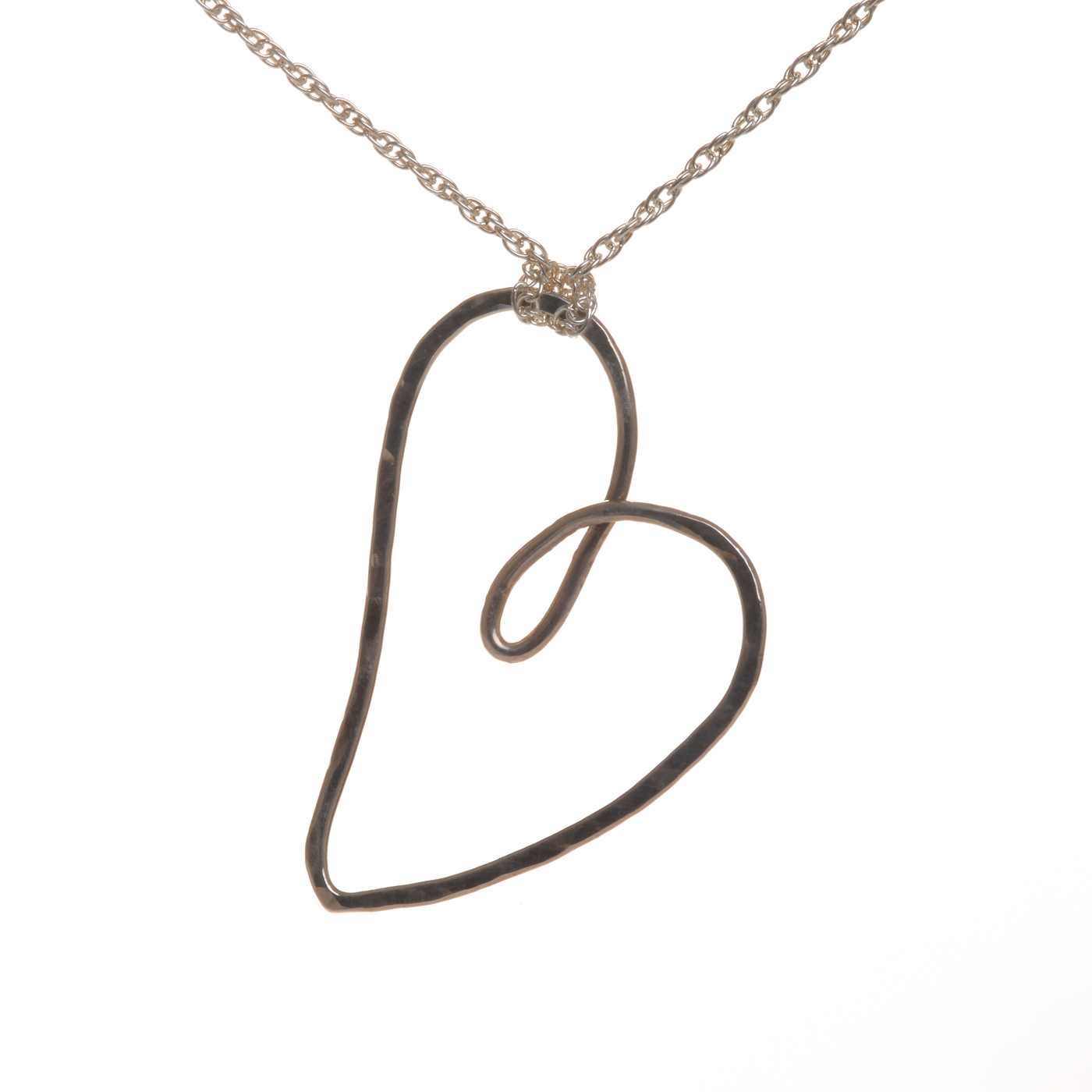 Beautifully designed and handcrafted "Love and Friendship" heart necklace by silversmith Suzanne Farran-Hrytzik of North Carolina. This piece features a playful sterling silver hammered heart. Great for everyday wear. Expect slight variations in design.