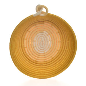 Handmade coiled rope bowl by artist Ann Oakes of North Carolina. Each bowl is a vibrant and unique piece of textile art. The durable rope core is meticulously wrapped in yarn, forming an eye-catching spiral design in shades of yellows and creams. Two intertwining loops on the  rim add a charming, artisanal touch, making it a perfect functional art piece for any home. Spot clean with a damp cloth or vacuum with a small vacuum cleaner.