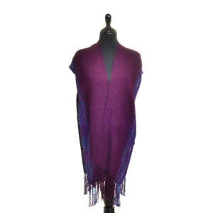 Handwoven Ruana shawl by artist Albena Fairchild. This statement piece features warmth, texture, and elegance, and can be worn multiple ways, making it a great addition to any outfit. Albena's pieces embody craftsmanship that blends traditional designs and techniques with modern styles. In her wide range of weavings, she is guided by the principles of beauty, function, and meaning. Wearables may be hand-washed or dry-cleaned. Lay flat to dry. Pre-washed in organic wash and ready to be enjoyed!