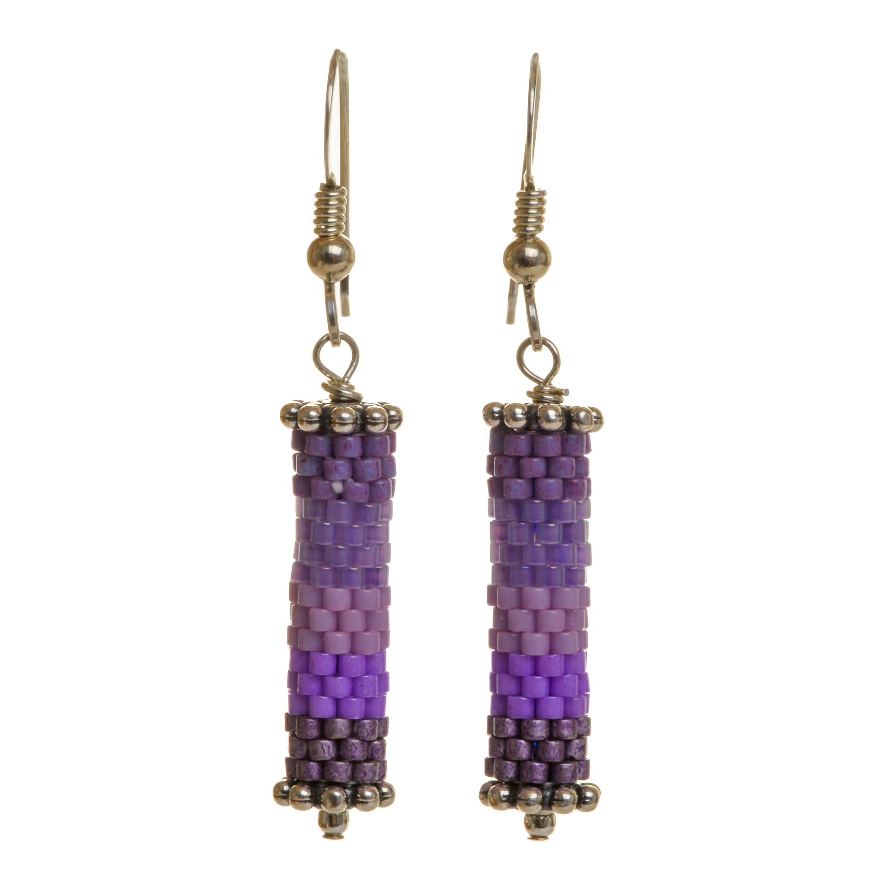 Round tube earrings featuring handwoven glass seed beads by jeweler Leslie Fawcett of Tennessee. With a needle and nylon thread, Leslie takes tiny glass seed beads and weaves them into larger beads that are then rolled up and sewn together. The use of the peyote stitch allows the ends of the rectangle to interlock when sewn together, and repeated passes through the beads reinforce the whole. Different colors available.