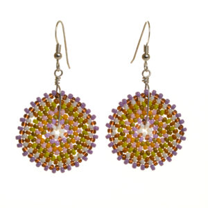 Round disc earrings featuring handwoven glass seed beads by jeweler Leslie Fawcett of Tennessee. With a needle and nylon thread, Leslie takes tiny glass seed beads and weaves them into larger beads that are then rolled up and sewn together. The use of the peyote stitch allows the ends of the rectangle to interlock when sewn together, and repeated passes through the beads reinforce the whole. Different colors available.