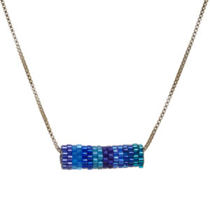 Round tube necklace featuring handwoven glass seed beads by jeweler Leslie Fawcett of Tennessee. With a needle and nylon thread, Leslie takes tiny glass seed beads and weaves them into larger beads that are then rolled up and sewn together. The use of the peyote stitch allows the ends of the rectangle to interlock when sewn together, and repeated passes through the beads reinforce the whole. Different colors available.