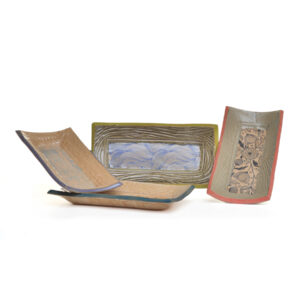 Small slab-built stoneware tray that combines functional design with intricate botanical artistry by North Carolina potter Robin Kirby Bryant. The original designs are hand-carved and painted on each piece. No two are alike, though they will share the feeling of belonging together. Dishwasher and microwave-safe. Different colors/designs available. Each sold separately. 