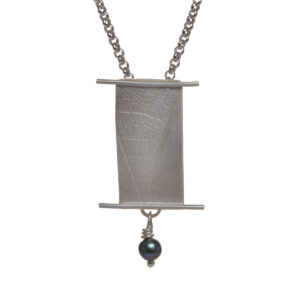 Asian Scroll Leaf Texture Pendant accented with a black pearl dangle made of handcrafted Argentium silver. The leaf texture is subtle and adds interest. Each item is unique, and no two are exactly the same. 