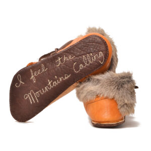 Anika Jaan 2026, American bison hide, deer hide, cottontail rabbit fur, elk antler, indigo dye, nylon thread, juke 1508, hand-patterned turnshoe style, skiver; tanning, hand cut, burnt, painted, dyed, sewing 4" x 4" x 11", approximately women's size 8 (custom-fitted commissions encouraged)