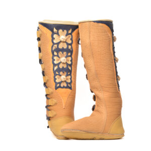 Anika Jaan 2026, American bison hide, deer hide, copperhead skin underlay, elk hide, elk antler, walnut dye, nylon thread; tanning, antler crowns cut, polished and dyed, deer applique flowers cut and torched for 3D effect 17½" x 4" x 10 ½", women's size 7 (custom-fitted commissions encouraged)