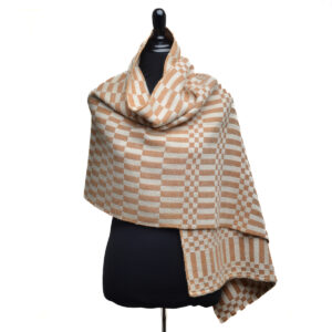 Handspun and handwoven cotton and silk shawl by fiber artist Eileen Hallman of North Carolina. Known for her mastery of natural indigo and botanical dyes, Hallman uses artisanal, pre-synthetic marbling methods, creating one-of-a-kind patterns with paints she crafts herself from earth pigments and foraged materials. Hand wash cold, line dry, iron on setting for  fabric setting.