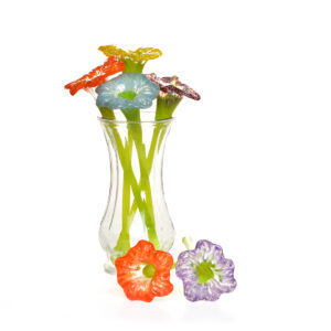Each hand-blown glass flower features individually sculpted petals and a graceful stem, creating an everlasting bloom full of color and light. Each flower is individually crafted by glass artist Dahlia Bushwick of Asheville, North Carolina.