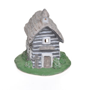 Hand-built clay sculpture crafted with detailed texturing and whimsical accents. Every side features sweet, intricate details that invite you to look closer. Cheryl Munyan is a potter from Burnsville who enjoys using clay to create representations of historic buildings and forgotten places. Through handcrafted sculptures and ceramic artwork, she strives to preserve the character, memories, and stories of the past.