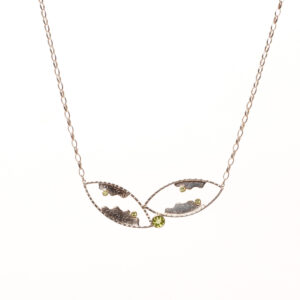 Vickie Napoli 2026, sterling silver, hand formed clasp, peridot; hammered, sawn, textured, sanded, soldered, polished 1” x 2 ¾” with 20 ½” chain