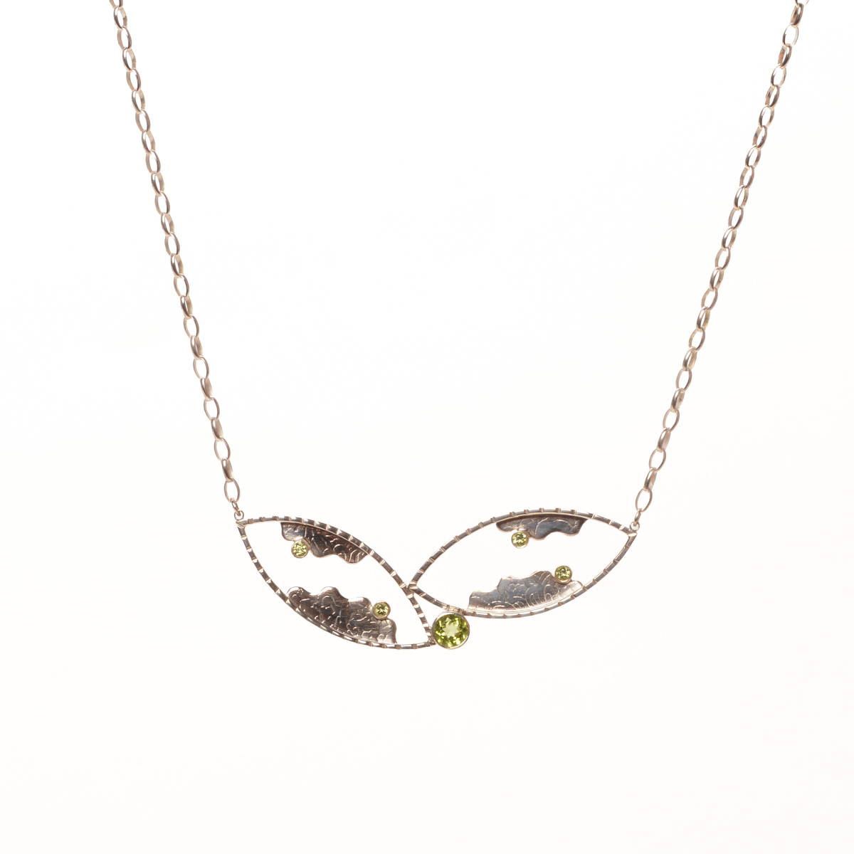 Vickie Napoli 2026, sterling silver, hand formed clasp, peridot; hammered, sawn, textured, sanded, soldered, polished 1” x 2 ¾” with 20 ½” chain