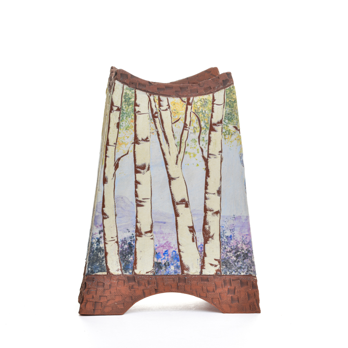 Enjoy a fresh batch of flowers or a dried arrangement in this handcrafted ceramic slab vase by Sharla Kaufman of North Carolina, featuring hand-built and hand-painted pieces that contrast the rawness of the earthenware with a “canvas” of white slip, on which a forest scene is applied using underglazes. Each piece is “framed” by raw clay, like a painting or looking through a window.