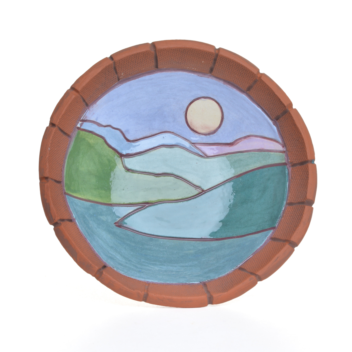 Small landscape ceramic dish featuring hand-built, hand-painted pieces that contrast the rawness of the earthenware with a “canvas” of white slip, on which landscape scenes are applied using underglazes. Each dish is “framed” by raw clay, like a painting or looking through a window. Each sold separately. Different colors available.