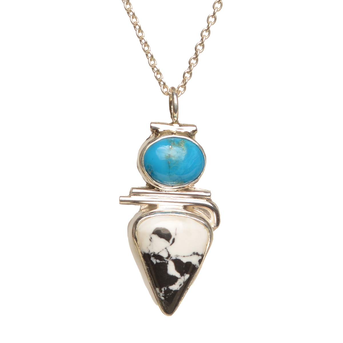 "Riders in the Sky" handcrafted sterling silver pendant featuring bold White Buffalo stone and Kingman turquoise by Ruthie Cohen of North Carolina. Bold contrasting colors and geometric lines merge seamlessly, creating a stunning statement piece.